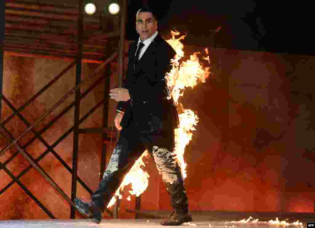 Indian Bollywood actor Akshay Kumar performs a fire stunt during the announcement of the upcoming Amazon Prime Video series &#39;The End&#39; in Mumbai.