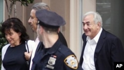 Dominique Strauss-Kahn, right, former head of the IMF leaves his house, accompanied by his wife, Anne Sinclair, left, for the first time after the judge changed the terms of his house arrest, Friday, July 1, 2011 in New York.