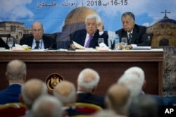 FILE - Palestinian President Mahmoud Abbas, center, speaks during a meeting with top decision-making body the Palestinian Central Council, at his headquarters in the West Bank city of Ramallah, Aug. 15, 2018.