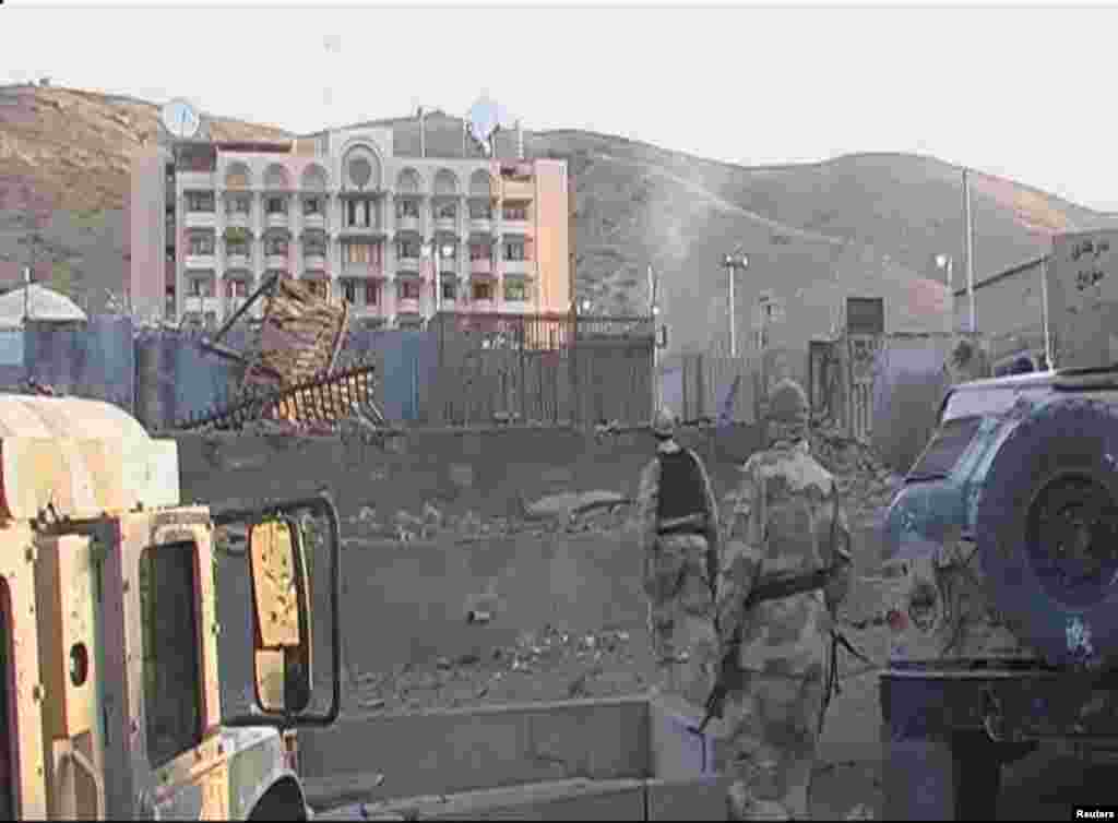 Soldiers walk towards the U.S. Consulate after an attack by insurgents in Herat, Afghanistan, Sept. 13, 2013.