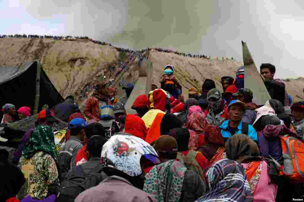 Mount Bromo spews ash as Hindu villagers and visitors gather ahead of Kasada ceremony, when villagers and worshipers throw offerings such as livestock and other crops into the volcanic crater in Probolinggo, Indonesia.