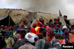 Mount Bromo spews ash as Hindu villagers and visitors gather ahead of Kasada ceremony, when villagers and worshippers throw offerings such as livestock and other crops into the volcanic crater of Mount Bromo, in Probolinggo, Indonesia, July 20, 2016.