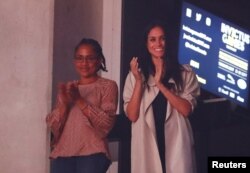 FILE - Meghan Markle, girlfriend of Britain's Prince Harry, and her mother Doria Ragland watch the closing ceremony for the Invictus Games in Toronto, Ontario, Canada, Sept. 30, 2017.