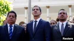 FILE - Juan Guaido, new President of the National Constituent Assembly and lawmaker of the Venezuelan opposition party Popular Will, flanked by lawmakers Edgar Zambrano, left, of Democratic Action party, and Stalin Gonzalez of A New Time party, Jan. 5, 2019. 