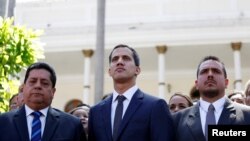 FILE - Juan Guaido, new President of the National Constituent Assembly and lawmaker of the Venezuelan opposition party Popular Will, flanked by lawmakers Edgar Zambrano, left, of Democratic Action party, and Stalin Gonzalez of A New Time party, in Caracas.
