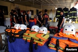 Rescuers ready their gear before Super Typhoon Mangkhut hits the main island of Luzon, in Muntinlupa, Metro Manila, Philippines, Sept. 13, 2018.