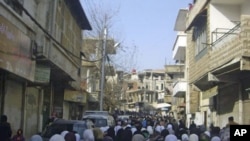 Anti-government protesters attend the funeral of protesters killed in earlier clashes in the Damascus suburb of Zabadani, Syria, December 21, 2011.