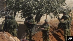 Israeli soldiers inspect the body of senior Hamas militant Nashad al-Karmi, in the West Bank city of Hebron, 08 Oct 2010