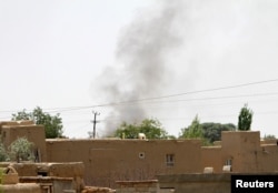 Smoke rises from a residential area where gun battle is going on between Taliban and Afghan forces in Ghazni province, Afghanistan Aug. 10, 2018.