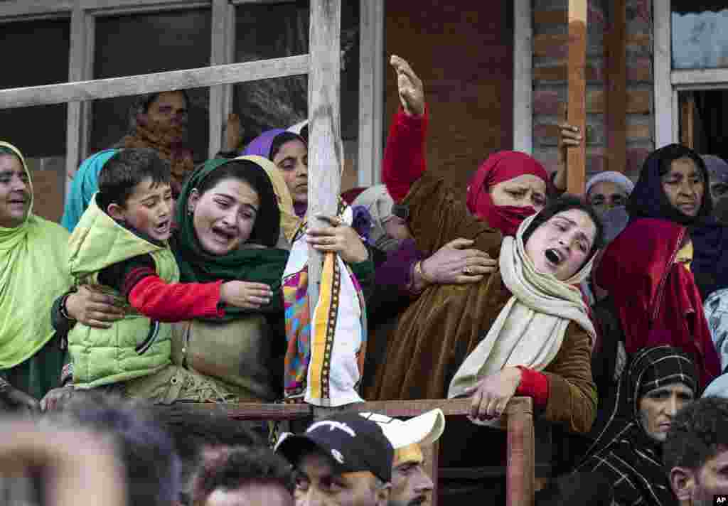 Relatives and family members cry near the coffin of elected official Riyaz Ahmad in Sopore, 55 kilometers (34 miles) north of Srinagar, Indian-controlled Kashmir.