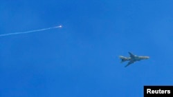 A Syrian Air Force fighter jet is seen near Damascus in this January 26, 2013, file photo (via Shaam News Network).