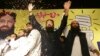 Sheikh Yaqub (C) candidate of the newly-formed Milli Muslim League party, waves to his supporters at an election rally in Lahore, Pakistan, Sept. 14, 2017.