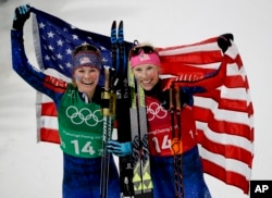 United States' Jessie Diggins, left, and Kikkan Randall celebrate after winning the gold medal in the women's team sprint freestyle cross-country skiing final at the 2018 Winter Olympics in Pyeongchang, South Korea, Feb. 21, 2018.