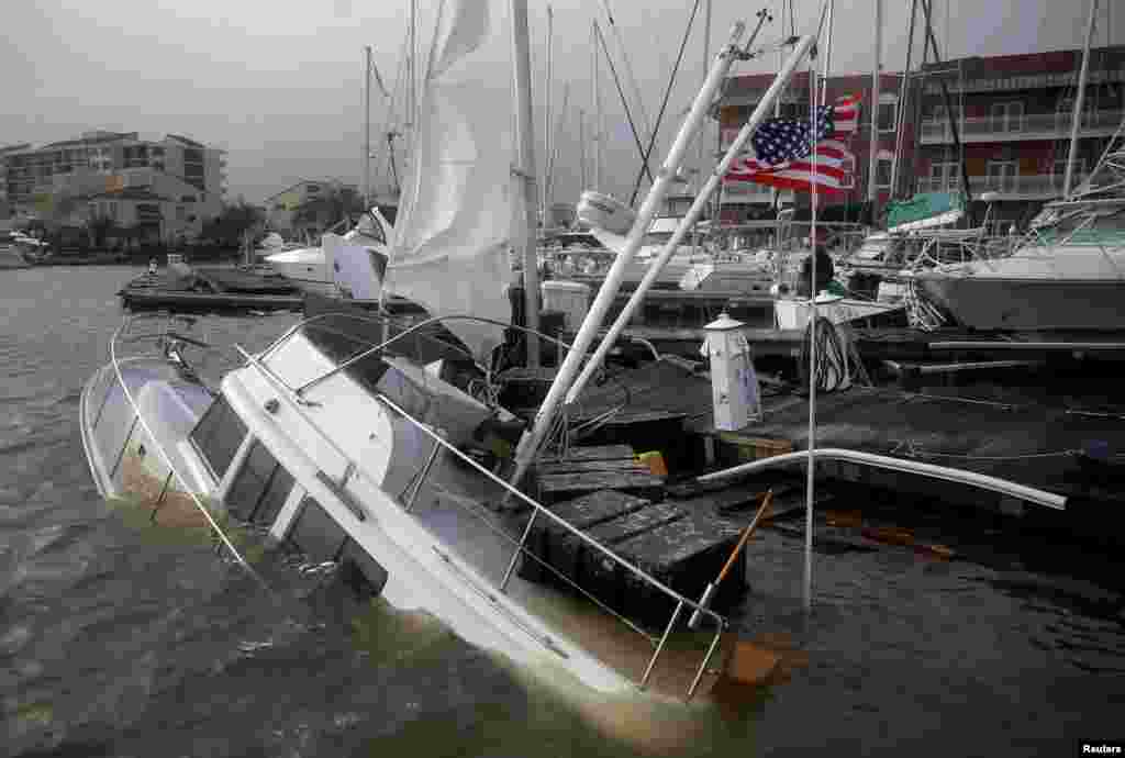 An U.S. flag flies from a boat damaged by Hurricane Sally in Pensacola, Florida, Sept. 16, 2020.