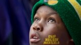 A boy with "Rest In Peace Nelson Mandela" painted on his face looks up to the skies during the memorial service for former South African president Nelson Mandela at the FNB Stadium in Soweto, near Johannesburg, South Africa, Tuesday Dec. 10, 2013. (AP Photo/Peter Dejong)