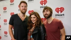 FILE - Lady Antebellum's Charles Kelley, Hillary Scott and Dave Haywood, from left, arrive at the iHeartRadio Country Festival in Austin, Texas, March 29, 2014.