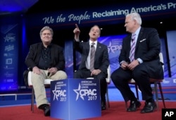 FILE - White House Chief of Staff Reince Priebus, center, with White House chief strategist Stephen Bannon, left, are seen during the Conservative Political Action Conference in National Harbor, Maryland, Feb. 23, 2017. Frictions with Priebus are said to have contributed to Bannon's demotion.