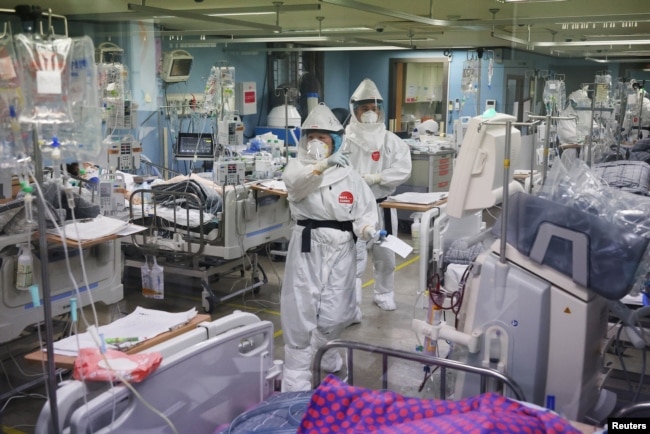 Medical workers check a COVID-19 patient at the intensive care unit (ICU) of Bagae Hospital in Pyeongtaek, South Korea, Nov. 29, 2021