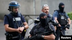 French police and anti-crime brigade (BAC) members secure a street as they carried out a counter-terrorism swoop at different locations in Argenteuil, a suburb north of Paris, France, July 21, 2016. 