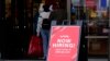 FILE - A hiring sign is displayed outside of a retail store in Vernon Hills, Illinois, Nov. 13, 2021.