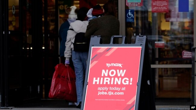 FILE - A hiring sign is displayed outside of a retail store in Vernon Hills, Illinois, Nov. 13, 2021.
