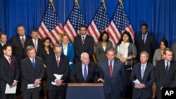 Senator John McCain, center, speaks about immigration reform legislation that would create a path for millions of unauthorized immigrants to apply for U.S. citizenship, April 18, 2013.