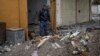 FILE - A member of the Federal Police stands next to unexploded bombs left by Islamic State group militants on the western side of Mosul, Iraq, March 22, 2017.