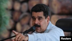 FILE - Venezuela's President Nicolas Maduro speaks during a visit to an industrial sawmill in Chaguaramas, Venezuela, Aug. 18, 2016.