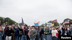 Protesters with the "Million Vet March on the Memorials" rally in front of the National U.S. World War II Memorial in Washington October 13, 2013.
