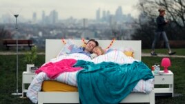 A couple lay in a double bed during a photo opportunity organised by the Mental Health Foundation to mark World Sleep Day, on Parliament Hill, in London, March 15, 2018.