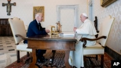 U.S. President Joe Biden talks with Pope Francis as they meet at the Vatican, Oct. 29, 2021. (Vatican Media via AP)
