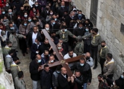 Umat Kristen dalam prosesi Jumat Agung di sepanjang Via Dolorosa di tengah pembatasan COVID-19, selama Pekan Suci Paskah di Kota Tua Yerusalem, 2 April 2021. (Foto: REUTERS/Ammar Awad)