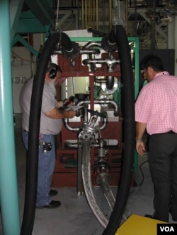 Engineers check the Green Machine, which converts waste heat into electricity, at Southern Methodist University in Dallas. (Courtesy SMU)