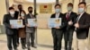 FILE - Eric Huang, newly appointed director to the representative office, third from right, poses with other staffers outside the Taiwan Representative Office in Vilnius, Lithuania, Nov. 18, 2021.