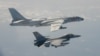 FILE - A Taiwanese F-16 fighter jet flies next to a Chinese H-6 bomber, top, in Taiwan's airspace, in this handout photo taken and released Feb. 10, 2020, by Taiwan's defense ministry.