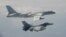 FILE - A Taiwanese F-16 fighter jet flies next to a Chinese H-6 bomber, top, in Taiwan's airspace, in this handout photo taken and released Feb. 10, 2020, by Taiwan's defense ministry.