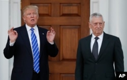 FILE - President-elect Donald Trump stands with retired Marine Corps Gen. James Mattis at Trump National Golf Club Bedminster clubhouse in Bedminster, N.J., Nov. 19, 2016.