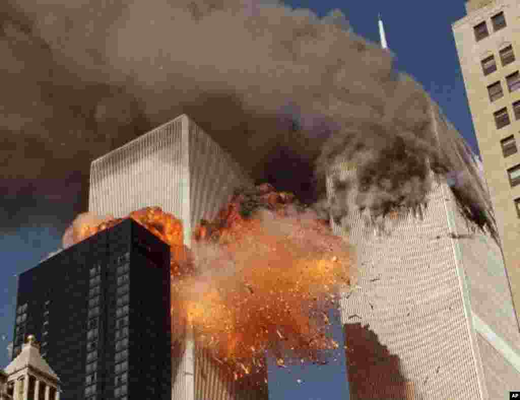 Smoke billows from one of the towers of the World Trade Center and flames and debris explode from the second tower, Tuesday, Sept. 11, 2001. In one of the most horrifying attacks ever against the United States, terrorists crashed two airliners into the Wo