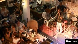 Guitarist Moustapha Diol addresses the audience at the Hotel De La Residence during the Saint Louis Jazz Festival in Saint Louis, Senegal, June 19, 2021. Picture taken June 19 2021. REUTERS/Cooper Inveen