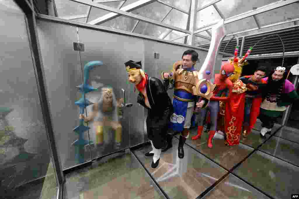 Cosplay actors pose for photos in a glass public toilet to mark World Toilet Day in Changsha in China&#39;s central Hunan province, Nov. 19, 2016.