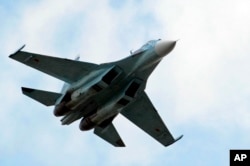 FILE - A Russian fighter jet flies during Venezuela's independence day military parade in Fort Tiuna in Caracas, Venezuela, July 5, 2006.