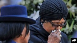 FILE - Winnie Madikizela-Mandela, Nelson Mandela's former wife, walks away after paying her respect to former South African President Nelson Mandela during the lying in state at the Union Buildings in Pretoria, South Africa, Dec. 11, 2013. 