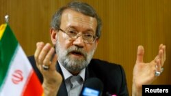 Ali Larijani, Speaker of the Iranian Parliament, gestures during a news conference after the 129th Assembly of the Inter-Parliamentary Union in Geneva, Oct. 9, 2013.