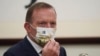 FILE - Former Australian Prime Minister Tony Abbott wears a mask with the Chinese character for "Australia" during a meeting with Taiwanese President Tsai Ing-wen, Oct. 7, 2021, at the Presidential Office in Taipei, Taiwan.