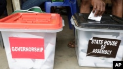 FILE - A man casts a ballot in Lagos, Nigeria, April 11, 2015. 