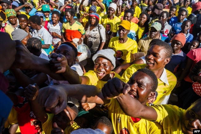 Supporters of ZANU PF cheer for their candidates for parliament after a ZANU PF election campaign rally addressed by Vice President Constantino Chiwenga at a school near Harare, on July 27, 2018.