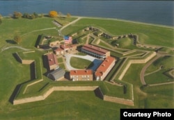 An aerial view of Fort McHenry. The 15-star flag shown is current, but it approximates the oversized flag that flew over the fort during the fateful bombardment of 1814. (National Park Service)