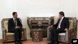 Turkish Foreign Minister Ahmet Davutoglu, right, meets with Syrian President Bashar al-Assad. in Damascus, August 9, 2011