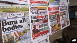 A close up of newspaper front pages focusing on the Ebola outbreak, including a newspaper, left, reading 'Burn all bodies' in the city of Monrovia, Liberia, Thursday, July 31, 2014. The worst recorded Ebola outbreak in history surpassed 700 deaths in Wes