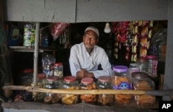 A Rohingya refugee Abdul Rahim, who runs a small grocery shop, waits for customers at a camp for the refugees in New Delhi, India, Aug. 16, 2017.